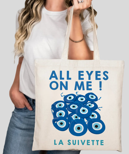 Tot bag en coton blanc "All Eyes On Me" avec motif d'yeux bleus Nazar Boncuk pour la protection contre le mauvais œil (La Suivette).